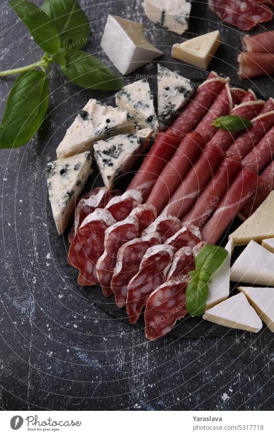 photo of sliced sausage and cheese assortment homemade meat snack restaurant food salami platter pork cuisine cut smoked dinner gourmet set bacon delicatessen