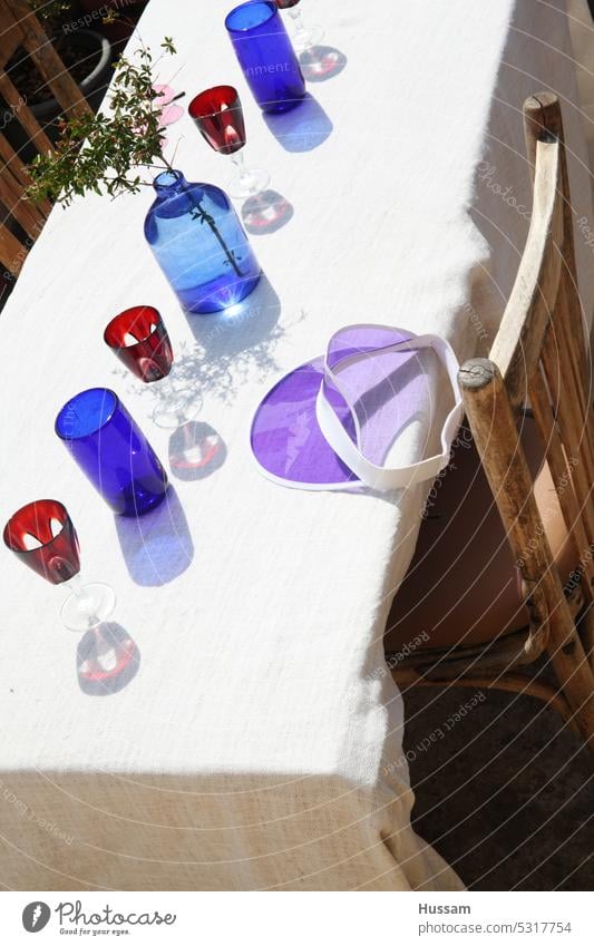 photo of design concept for table with colorful bottles and glasses and reflections lovingly decorated affectionately Glass table decoration Outdoor tablecloths