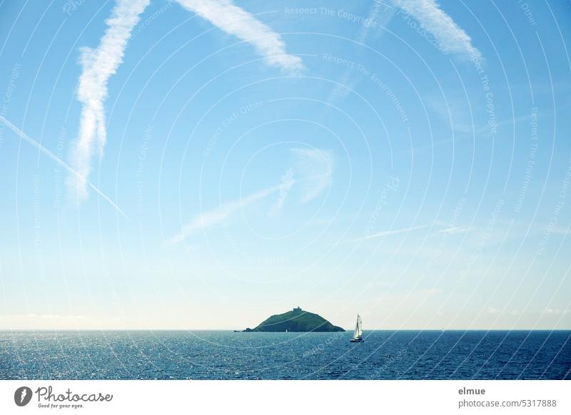 small uninhabited island with lighthouse in the Mediterranean Sea, sailboat and chemtrails / Scoglietto di Portoferraio Island Mediterranean sea Italy Sailboat