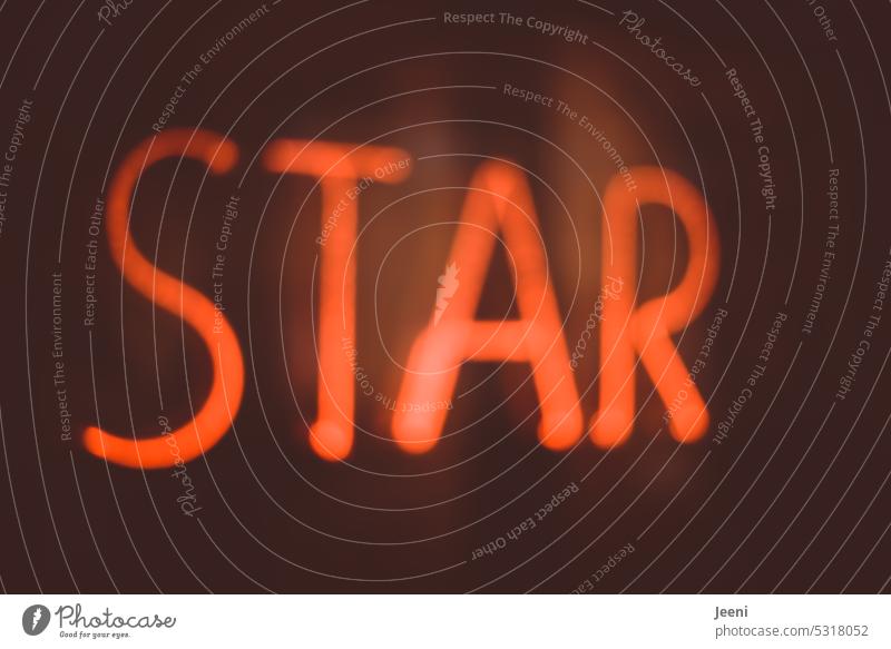 star Starling famous Celebrity Business Shows Television movie Music Light Word Red Letters (alphabet) Text Signs and labeling Illuminate hazy Advertising