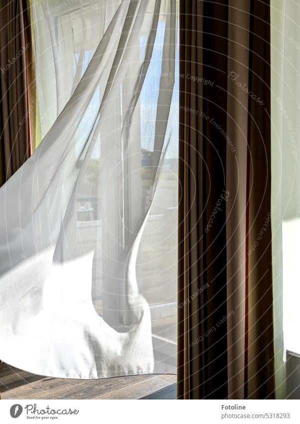 The wind plays with the curtain of my hotel room. Outside, the sun is shining. So out with me. You don't stay inside in weather like this. Curtain Cloth Wind