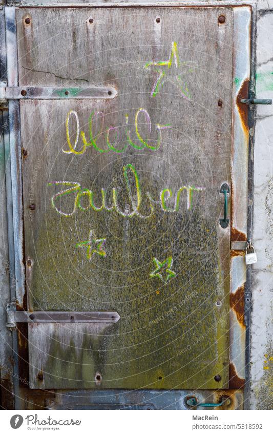 Inscribed wooden door Wooden door Labeled Painted colored Exterior shot nobody
