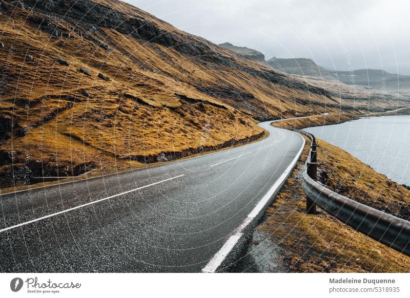 Road along the fjords in the Faroe Islands Street Fjord färöer foggy Adventure North moody road trip Asphalt Freedom curvy windy stunning voyage Picturesque
