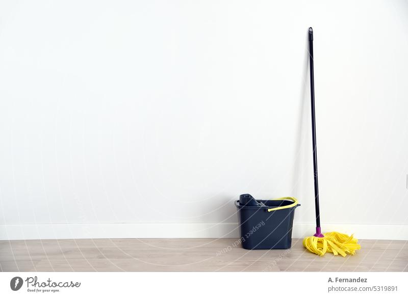 A mop and bucket in an empty room on a blank wall. cleaning moped Cleaning Bucket Work and employment Colour photo Dirty Broom Spring cleaning white background
