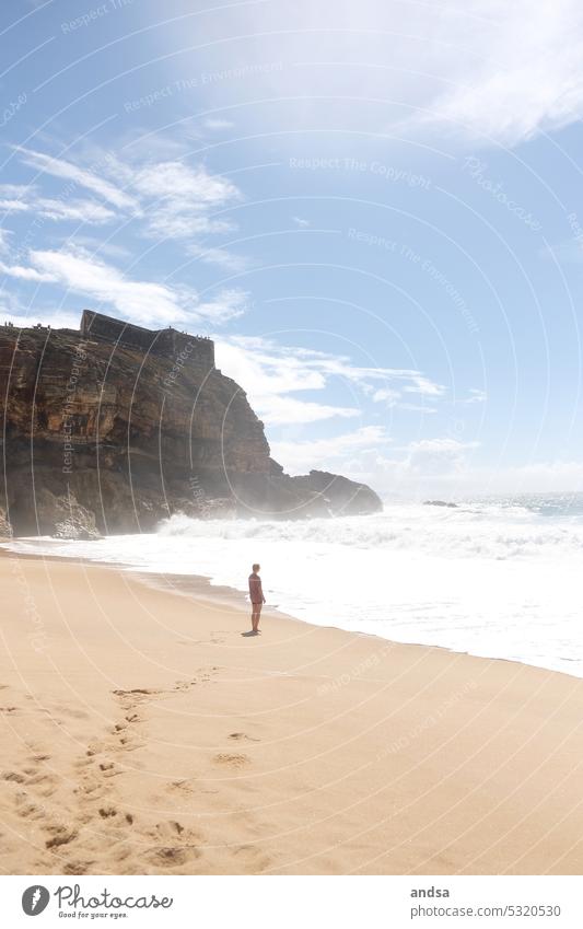 Woman on beach looking out to sea Beach Ocean cliff Waves Sand Sandy beach Portugal Nazaré coast Beautiful weather Water Exterior shot Nature Summer