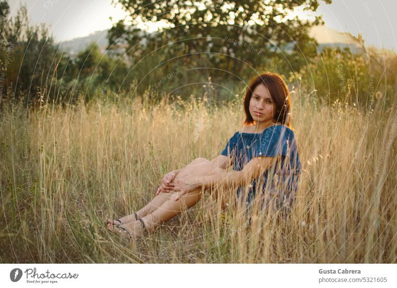 Woman sitting on the grass, contemplating nature. relax relaxing time lifestyle portrait girl Nature Natural Landscape young female people resting outdoor