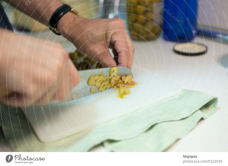 Man hands cutting olives. Japanese knife people ingredient human cuisine work chef background caucasian close up closeup cloth cooking culture delicious detail