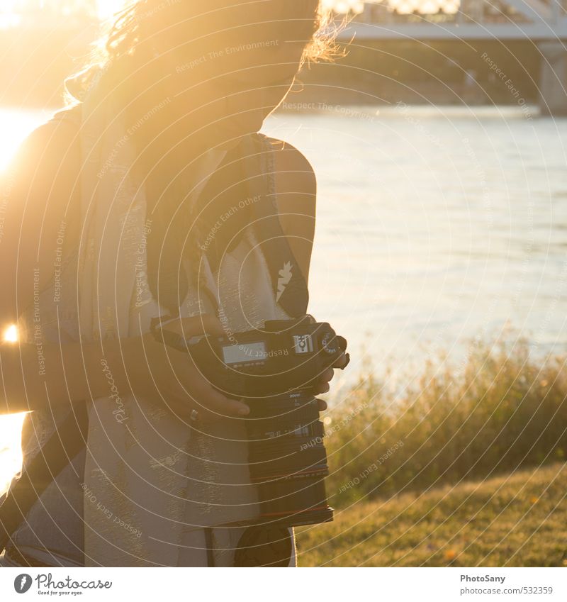in the glistening sunlight Camera Human being Feminine 1 Looking Warmth Yellow Contentment Photographer Mannheim River Colour photo Exterior shot