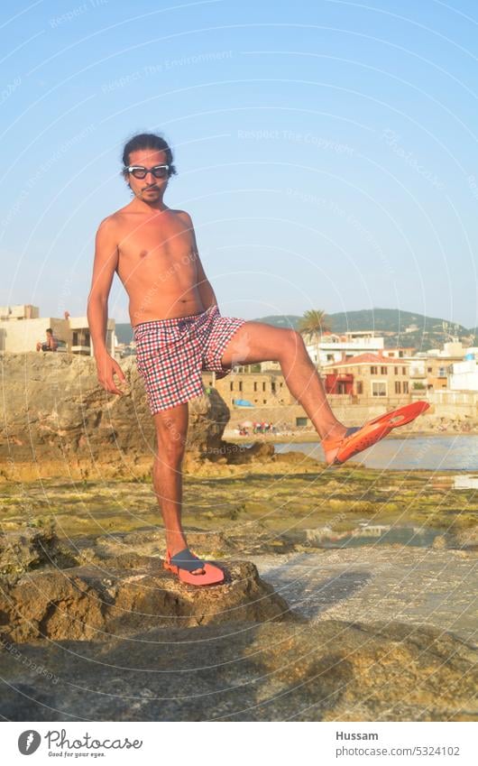 photo about a guy wearing goggles and swim-fins on his feet preparing himself to swim in funny pose Water wings Vacation & Travel Diving goggles Fin Diver