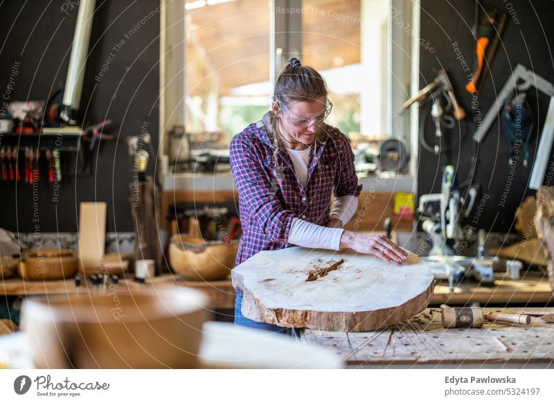 Craftswoman working with wood in carpentry workshop real people woodshop carpenter entrepreneur expertise craftsperson creativity manufacturing crafts people