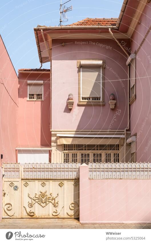 Facades of old houses in soft shades of pink and red behind ornate fence Town dwell Apartment Building House (Residential Structure) Pink Orange Red warm colors
