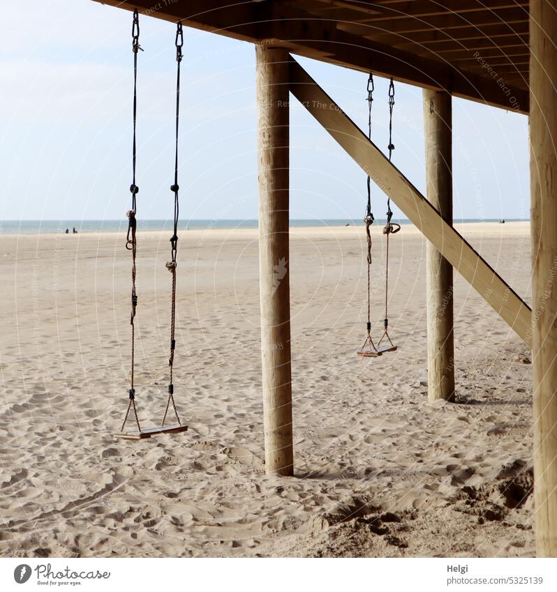 two swings on a pile on the beach Swing Beach Sand coast North Sea coast dutch Netherlands Ocean Lake dwelling Wood stake Hang Sky Water holidays Relaxation