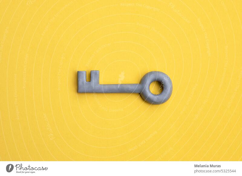 Plasticine key on yellow background. Safety, protection concept, internet password, security concept. Access or privacy symbol. access accessibility achievement