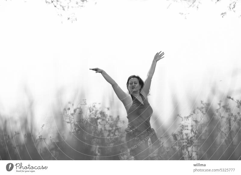 Woman dancing behind grasses in may Dance Joy Experience nature To enjoy man and nature Human being Mature woman Arm harmony Feminine Nature B/W
