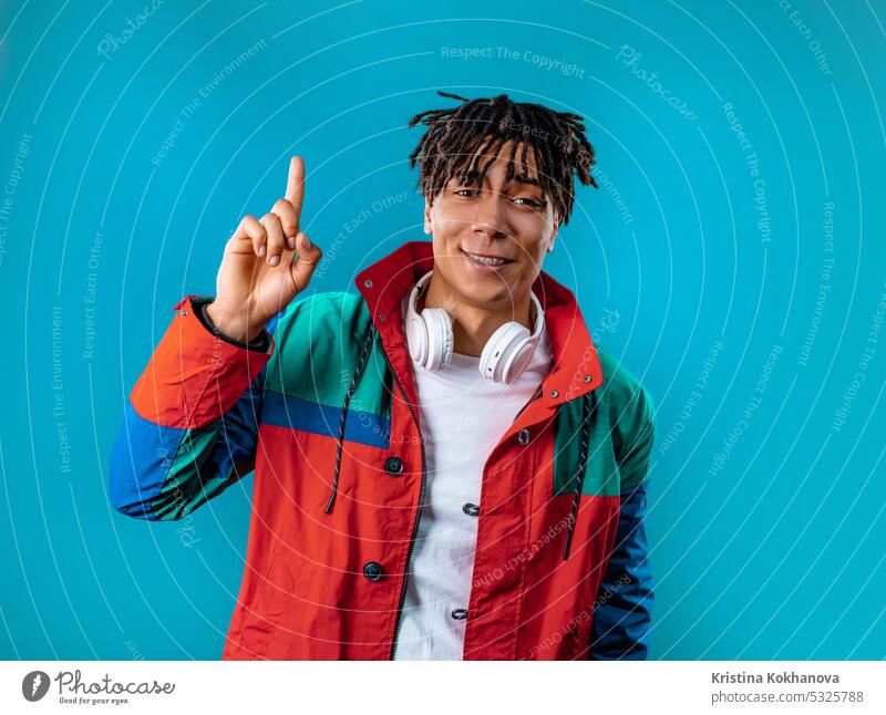 Brainy man having idea eureka moment, pointing finger up on blue. Solution. adult answer background casual caucasian cheerful confident expression face genius