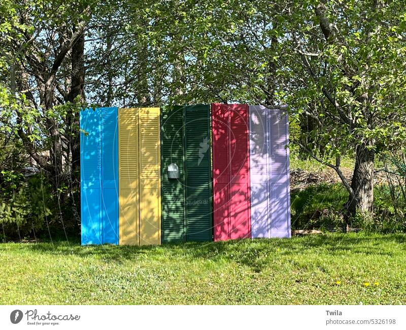 Colourful privacy fence made of doors bright colourful green spaces happy joyful DIY Pretty cheerful