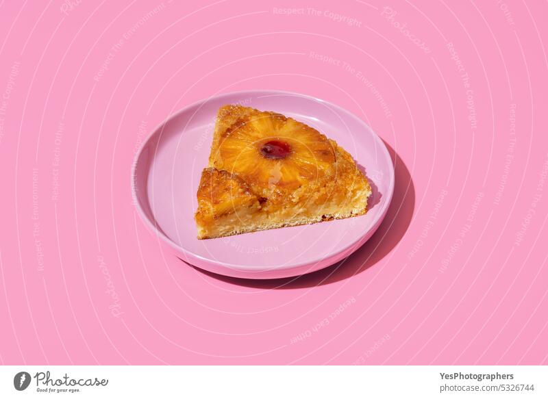 Pineapple cake slice on a plate isolated on a pink background ananas baked bakery bright caramel color cuisine cut out delicious dessert dish food fruit golden