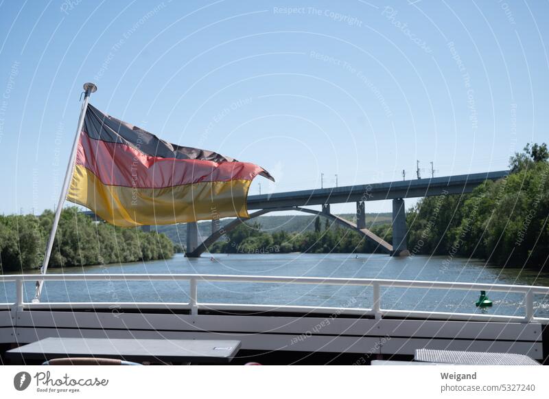 Germany flag in the wind on a ship in front of a bridge Bridge Main Company Flag policy Water