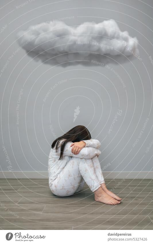 Woman with mental disorder and suicidal thoughts crying under a dark cloud unrecognizable woman suicide health desperate sitting floor concept conceptual