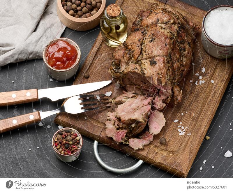 Baked pork collar with spices on a wooden board, delicious and juicy meat baked roasted seasoning flavors succulent tender marinated savory appetizing oil sauce