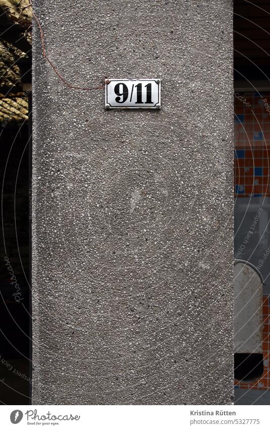 9/11 nine eleven House number House (Residential Structure) Wall (building) Facade out Sign sign Building address label Orientation real estate Enamel Date
