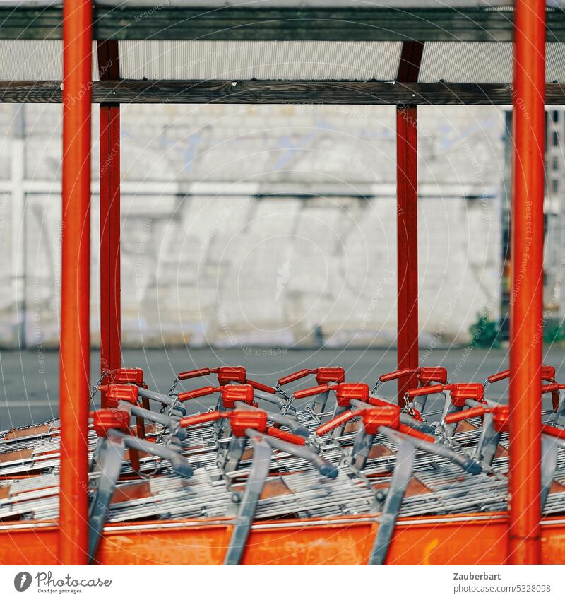 Red supermarket shopping carts, columns in red, parking lot Shopping Trolley Supermarket purchasing Shopping malls Parking lot Retail sector Hypermarket