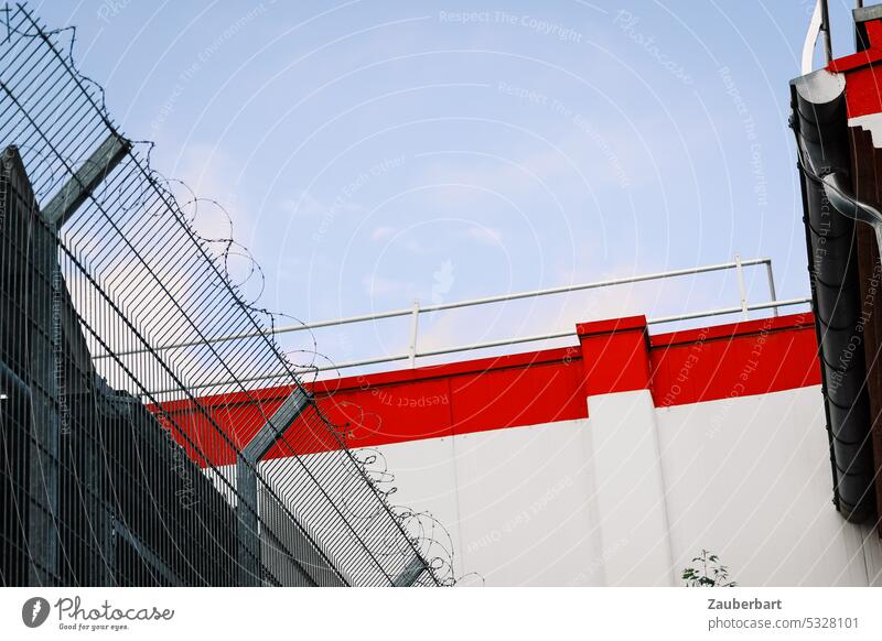 Fence with barbed wire, wall with red bar, back of supermarket Barbed wire Wall (barrier) Red Rear side Insight Safety Abstract urban Barrier Protection Border