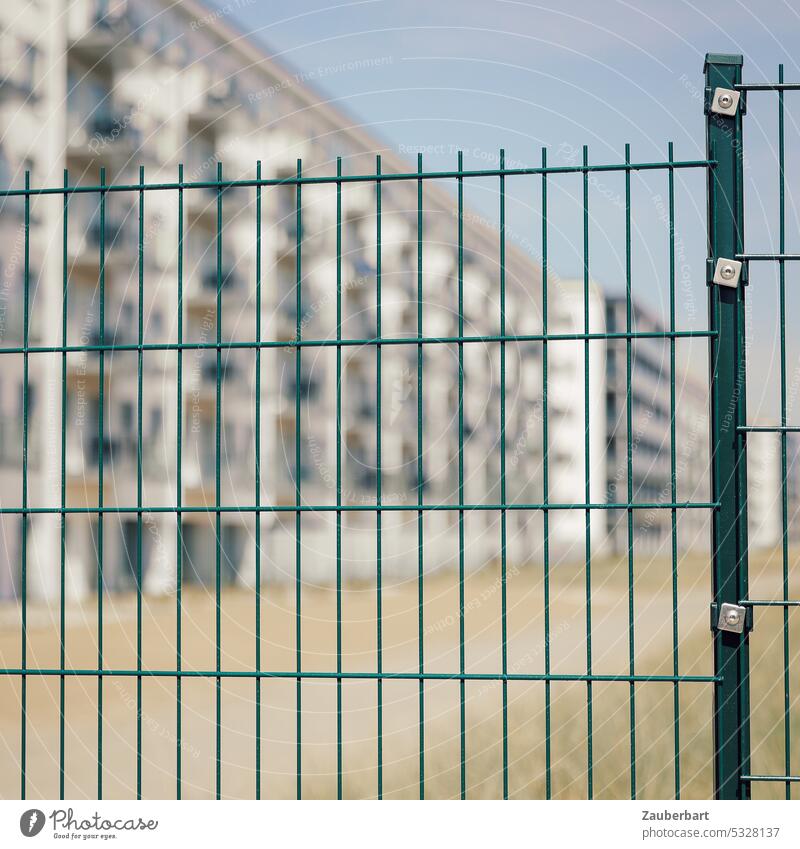Modern residential complex with apartments behind a new lattice fence Apartment Building Housing area High-rise holiday flats Fence Grating rectangular lock