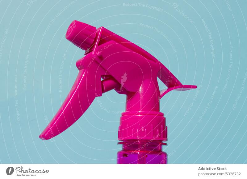 Pink atomizer on blue background spray plastic tool pink equipment bottle hygiene object detail simple creative reflection bright clean element shape light
