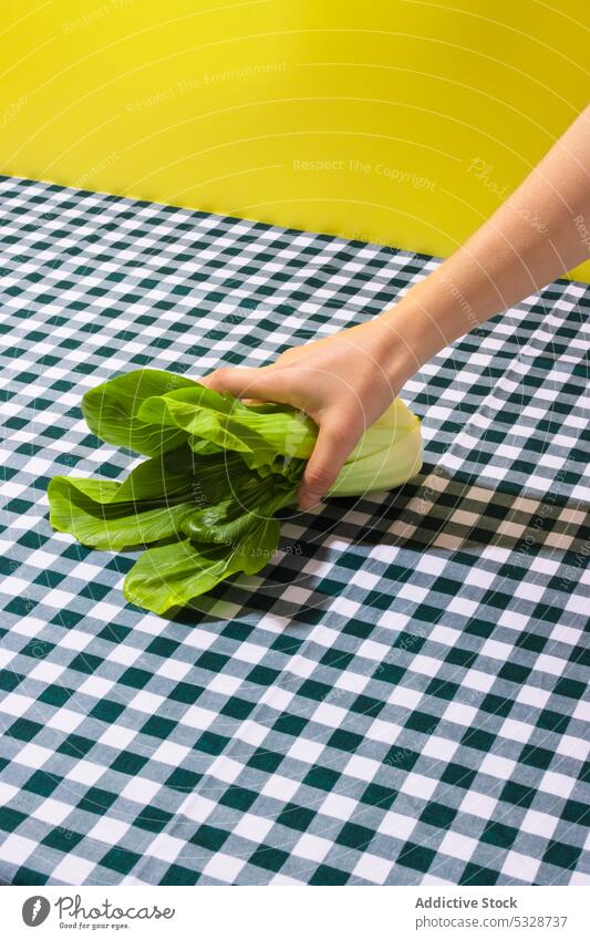 Unrecognizable person taking green cabbage from table bok choy napkin vegetable food cook fresh healthy organic meal vegetarian diet vegan nutrition ingredient