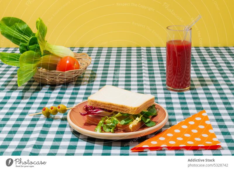 Delicious smoothie and healthy sandwich on checkered tablecloth salad tomato juice lettuce healthy food refreshment drink breakfast lunch eco friendly
