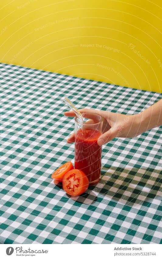 Crop person taking glass of tomato juice tablecloth vegetable refreshment organic ripe vitamin healthy food straw eco friendly zero waste delicious tasty drink