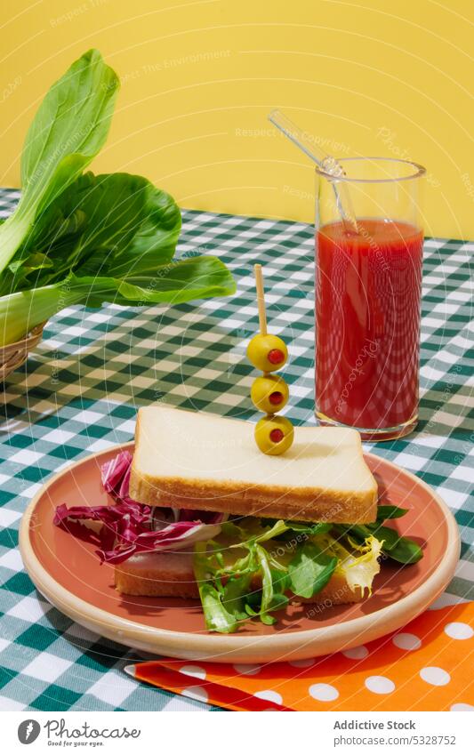 Delicious smoothie and healthy sandwich on checkered tablecloth salad tomato juice lettuce healthy food refreshment drink breakfast lunch eco friendly beverage