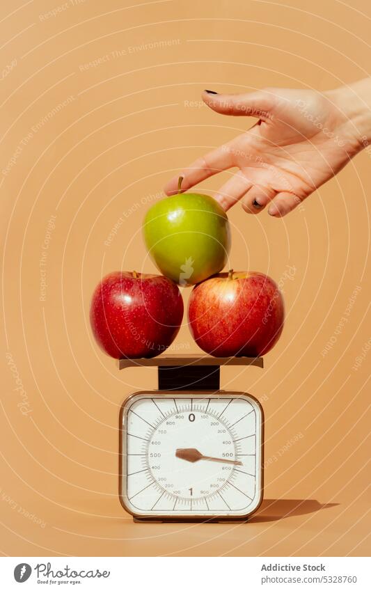 Crop woman weighing fresh apples on scale hand weight concept fruit diet healthy balance healthy food vitamin female healthy lifestyle stack green red organic