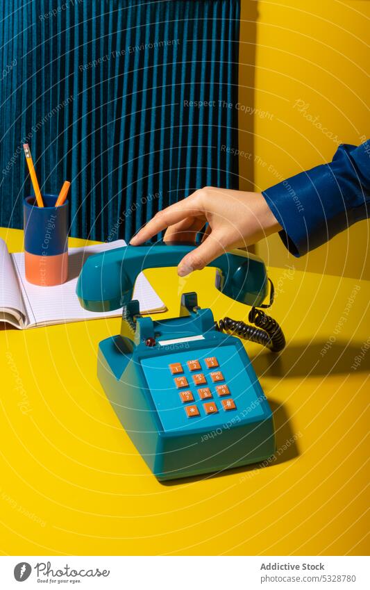 Person hanging up phone placed near office supplies person hang up handset retro stationary telephone notebook planner supply old fashioned vintage creative