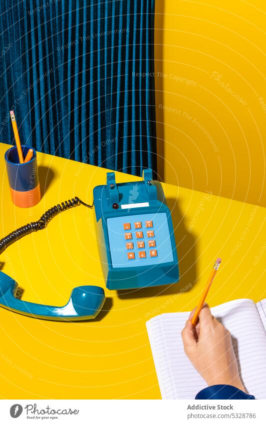 Person writing notes in notebook in workplace person take note write organizer handset retro stationary telephone old fashioned creative vintage device gadget