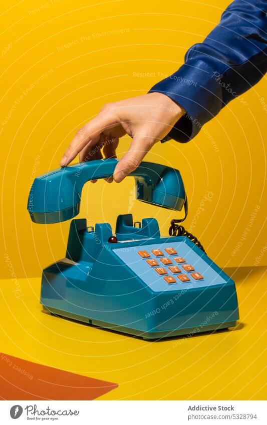 Person hanging up phone on yellow background person hang up handset retro stationary telephone supply old fashioned vintage creative button wire device gadget