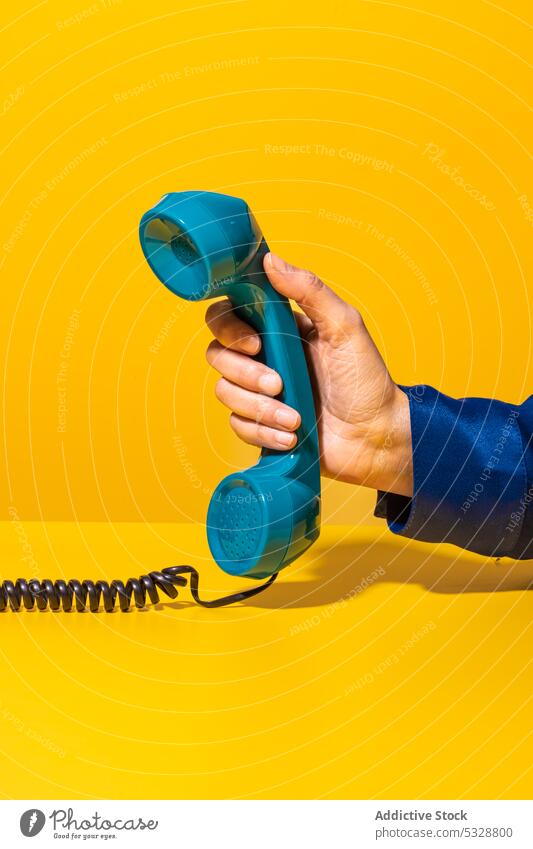 Person taking phone placed on table person handset retro stationary telephone notebook organizer hang up call communicate connection wire line device gadget