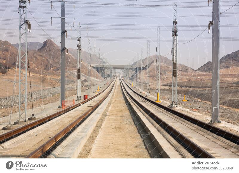 Railroad with powerlines under construction in summertime railway pole railroad electric environment development industrial track parallel infrastructure