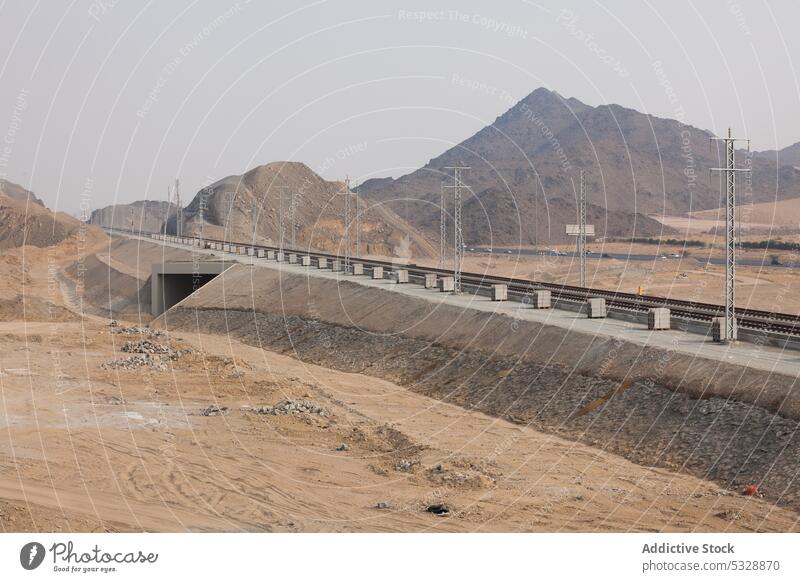 Construction of bridge with railway road under construction railroad water pole track river rain nature infrastructure mountain hill scenery location