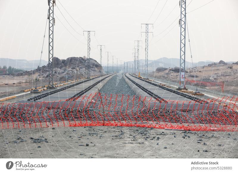Rows of railway tracks with electric supply lines railroad infrastructure net development construction terrain transport equipment speed nature daytime land