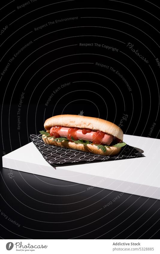 Appetizing hot dog on napkin over black table delicious fast food yummy organic fresh minimal contrast sausage ketchup sweet meal nutrition appetizing tasty
