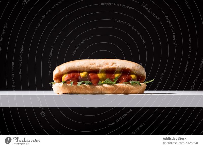 Appetizing hot dog on napkin over black table delicious fast food yummy organic fresh minimal contrast sausage ketchup sweet meal nutrition appetizing tasty