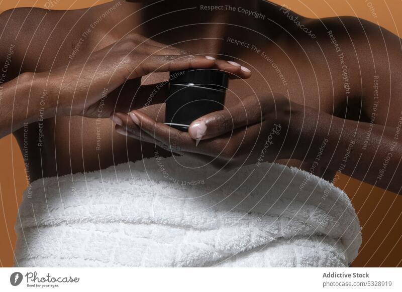 Crop black woman showing cosmetic product bottle cream skin care moisture demonstrate mockup advertise beauty lotion treat wellness feminine display gentle lady