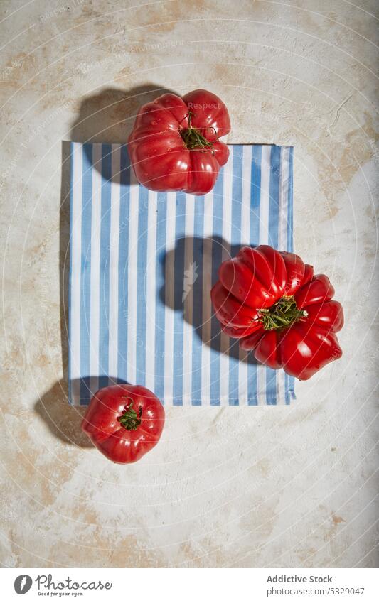 Ripe tomatoes on tablecloth over plane surface red fresh checkered ripe healthy tasty vegetable organic ingredient natural vitamin food nutrition vegetarian raw