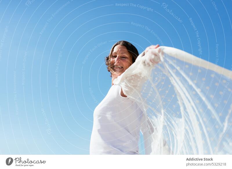 Woman extended arms against blue sky woman spin around outstretch cloak stroll vacation summer nature female holiday enjoy travel freedom tourism alone leisure