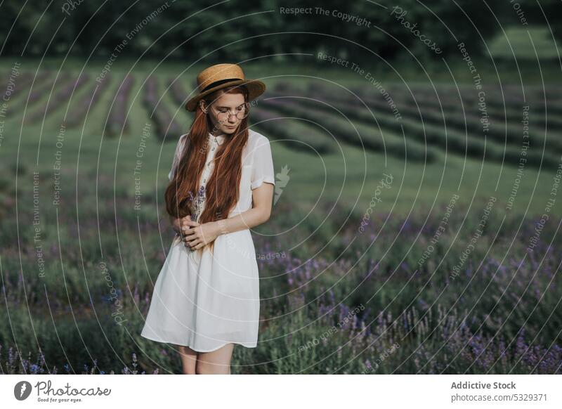 Woman with flowers in countryside field woman nature lavender meadow blossom bloom red hair eyewear glasses dress female eyes closed young elegant white dress