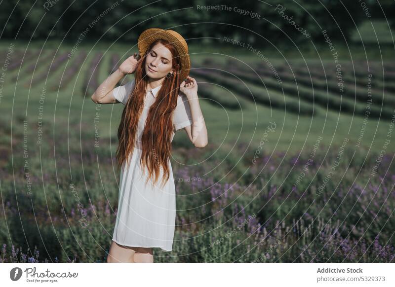 Woman with flowers in countryside field woman nature lavender meadow blossom bloom red hair feminine dress female eyes closed young elegant white dress style