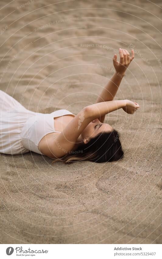 Woman resting on beach in gloomy weather woman sand chill summer sensual dream tender gentle cover face female sundress model tourism journey vacation holiday