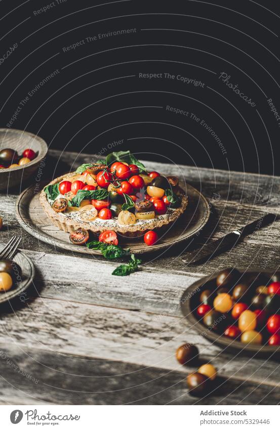 Vegan tart served with cherry tomatoes and herbs pie plate food vegetable healthy delicious fresh tasty meal baked dish ripe yummy appetizing rustic plant based